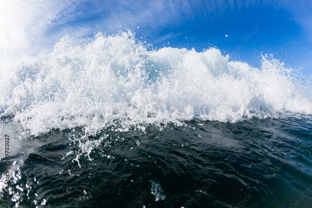 Wave Swimming inside ocean blue water crashing closeup.