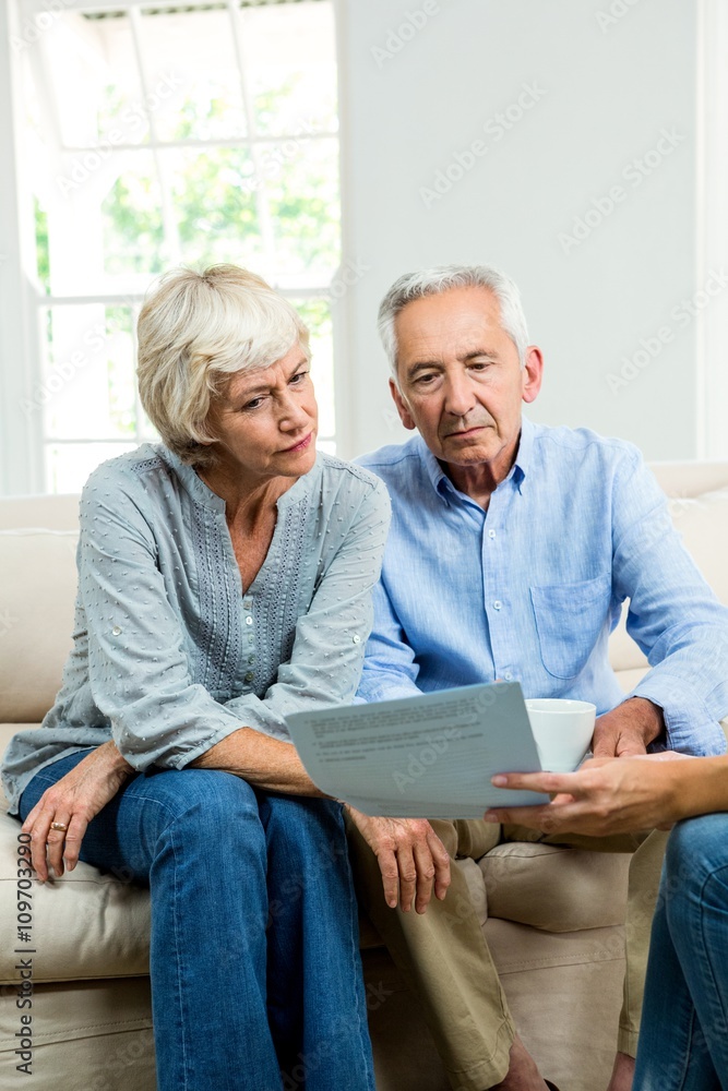 Cropped image of consultant showing report to senior couple Cropped image of consultant showing report to senior couple