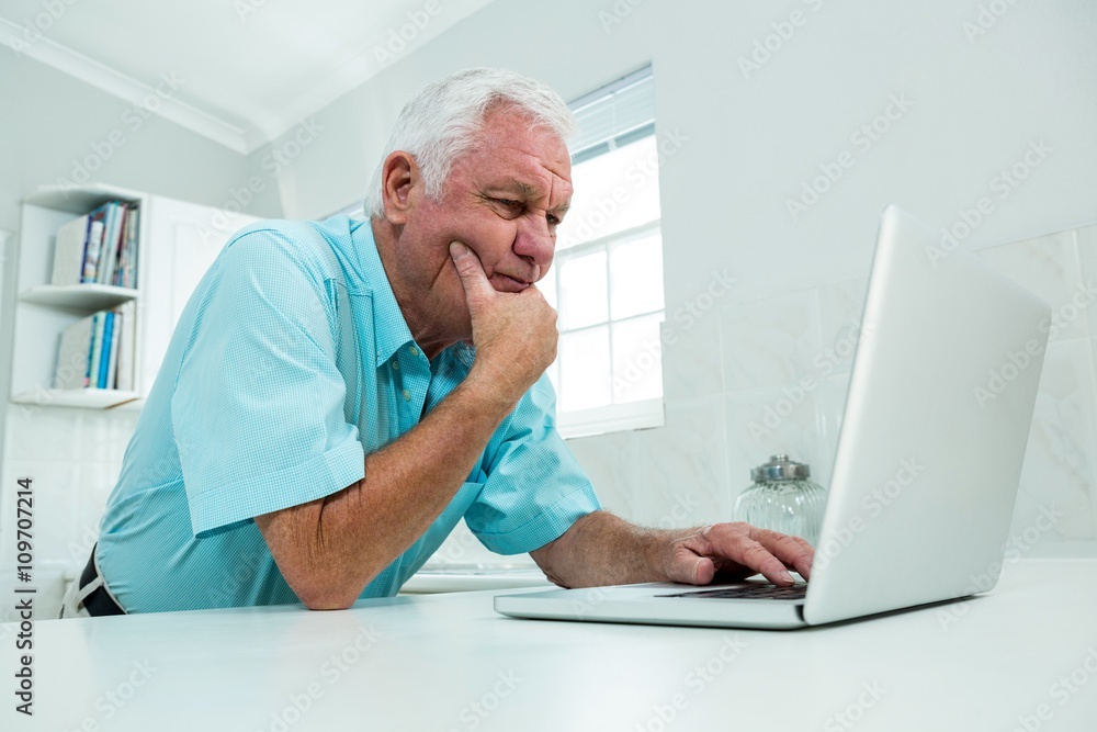 Thoughtful senior man with laptop Thoughtful senior man with laptop