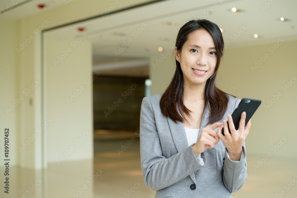 Business woman sending sms on cellphone