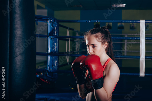 young boxing girl doing exercises on a boxing ring © kurapatka