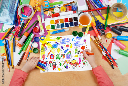 cartoon people and funny toy collection   child drawing  top view hands with pencil painting picture on paper  artwork workplace