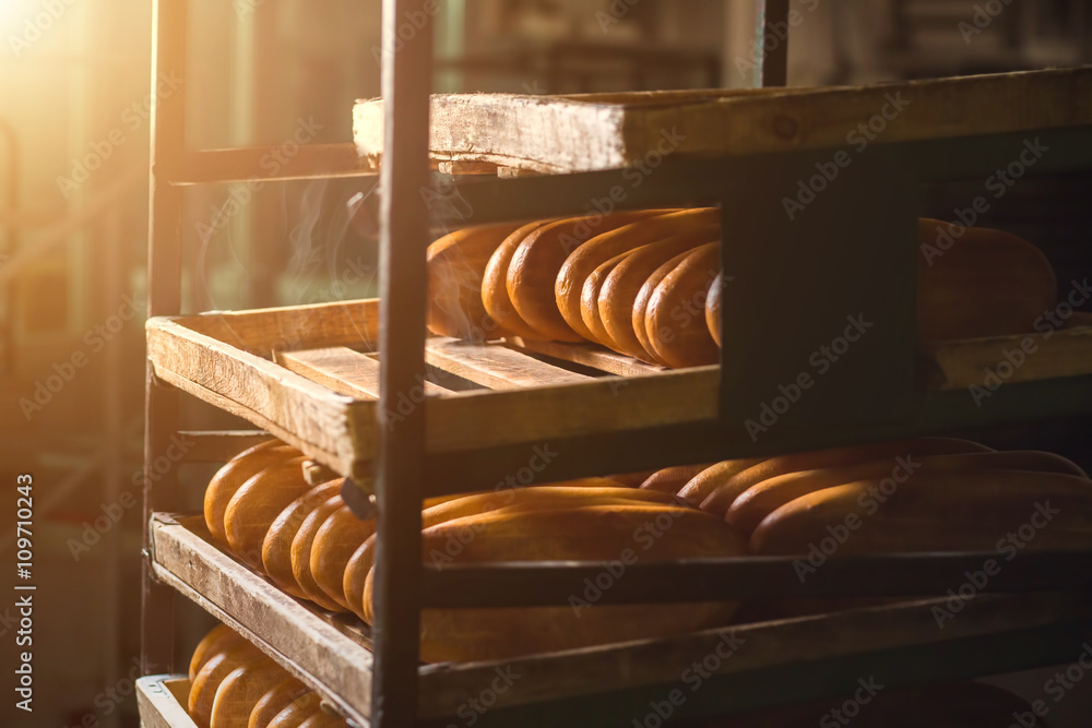 Long yellow loaves of bread. Bread laying on shelves. Fresh bread from