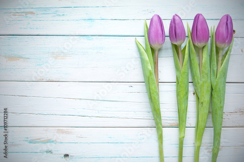 Tulips on wooden background