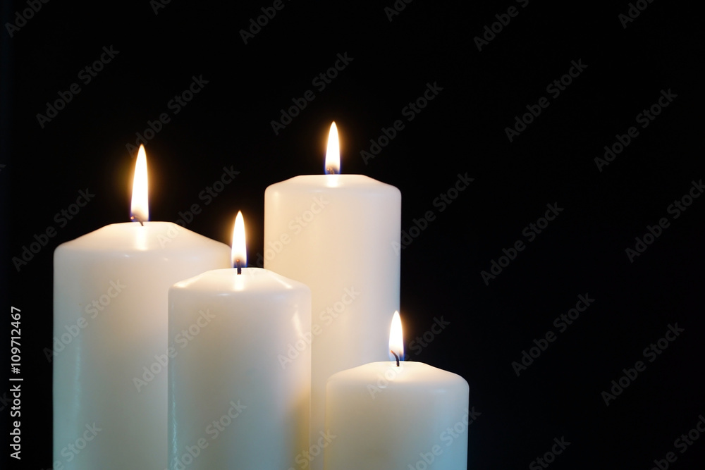 burning candles isolated on black background. burning candles isolated on black background.