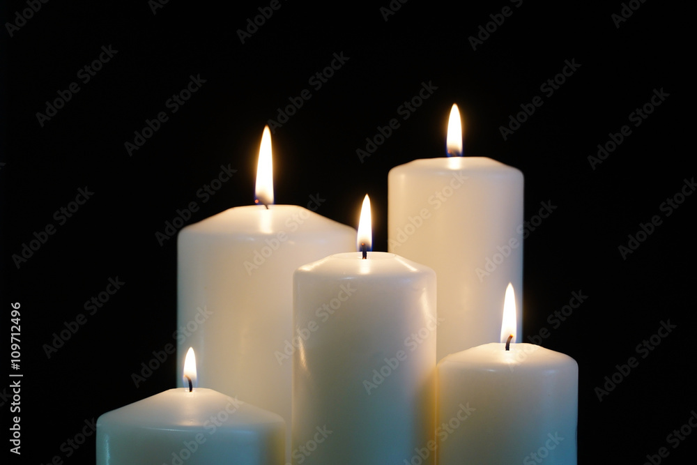 burning candles isolated on black background. burning candles isolated on black background.