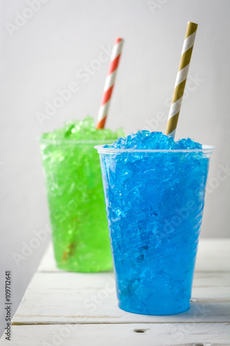 Colorful summer slushies on white wood