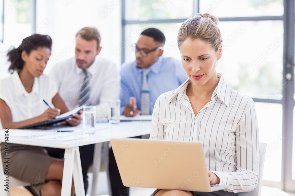 Businesswoman using laptop in office Businesswoman using laptop in office