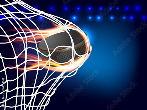 Flying burning hockey puck in goal