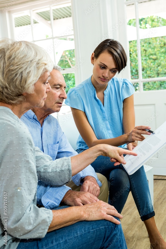 Female consultant reading report with senior couple Female consultant reading report with senior couple