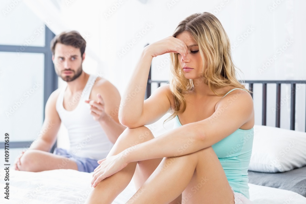 Young couple into an argument on bed Young couple into an argument on bed