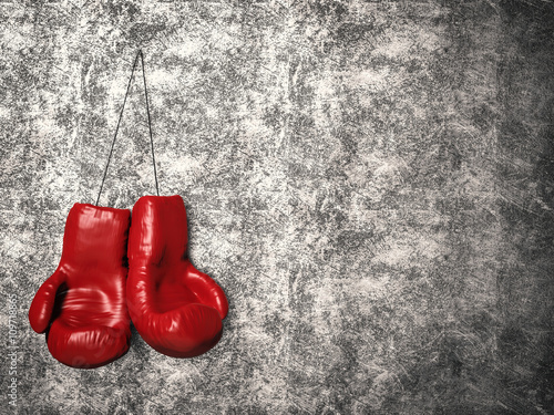red boxing gloves on cement background