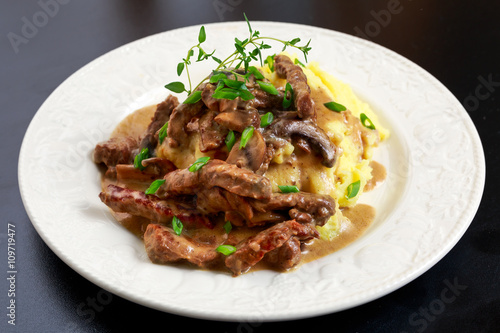 Beef Stroganoff with mashed potatoes on wooden table