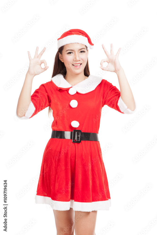 Asian Christmas girl with Santa Claus clothes show OK sign Asian Christmas girl with Santa Claus clothes show OK sign