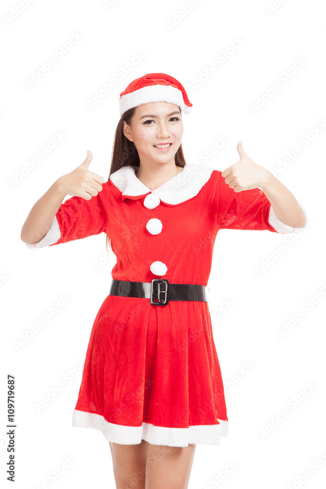 Asian Christmas girl with Santa Claus clothes show thumbs up Asian Christmas girl with Santa Claus clothes show thumbs up