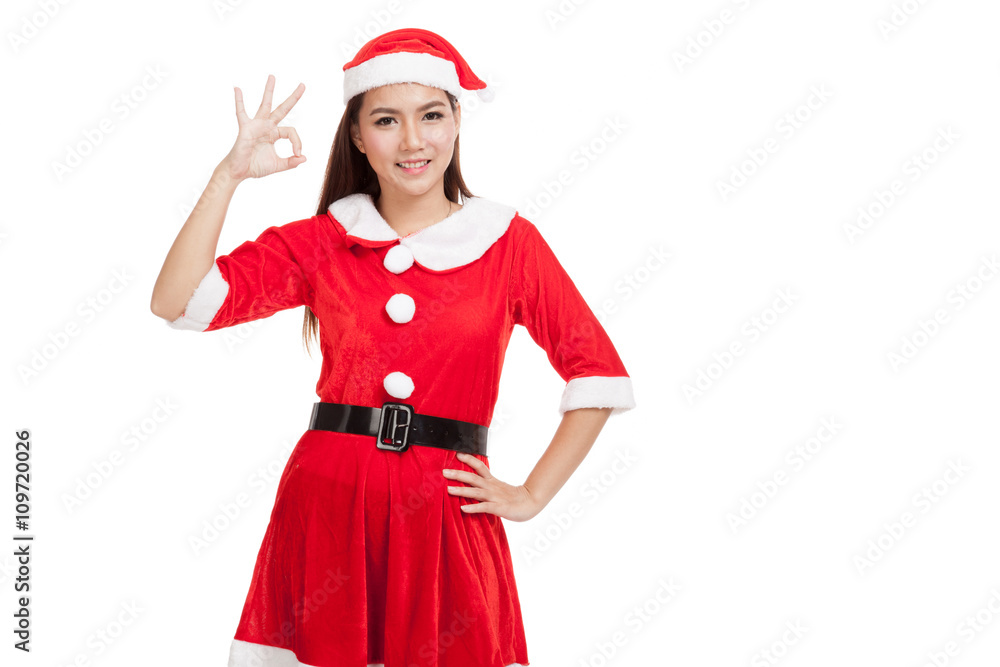 Asian Christmas girl with Santa Claus clothes show Ok sign Asian Christmas girl with Santa Claus clothes show Ok sign
