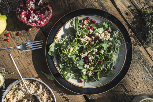 Green salad with pomegranate, manna croup and onion