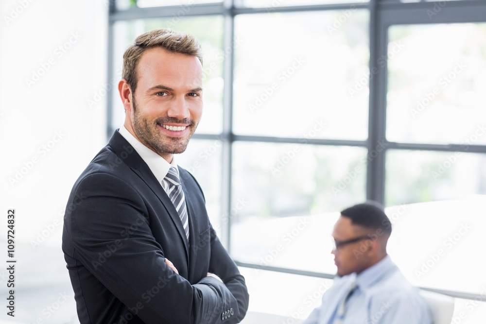 Happy businessman standing with arms crossed Happy businessman standing with arms crossed
