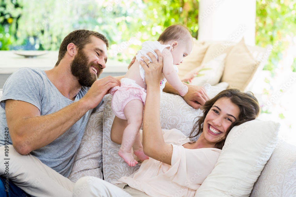 Happy parents playing with their baby Happy parents playing with their baby