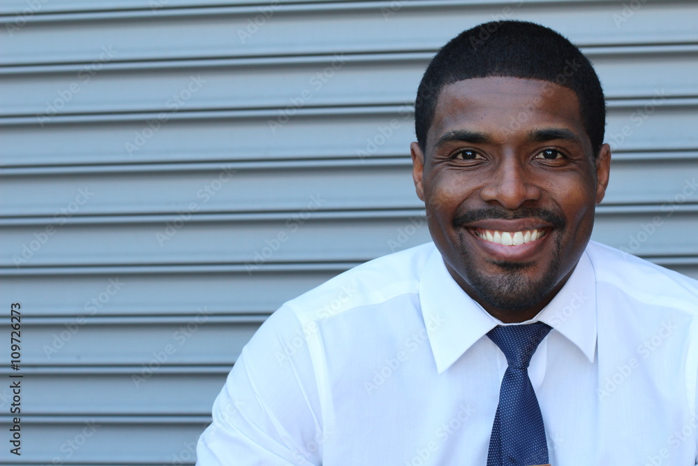 Portrait of handsome confident young African businessman smiling happy, looking at camera with copy space Portrait of handsome confident young African businessman smiling happy, looking at camera with copy space
