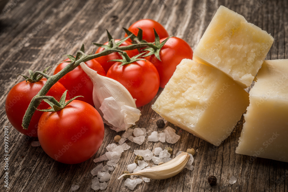 Pecorino and cherry tomatoes on rustic wooden table Pecorino and cherry tomatoes on rustic wooden table