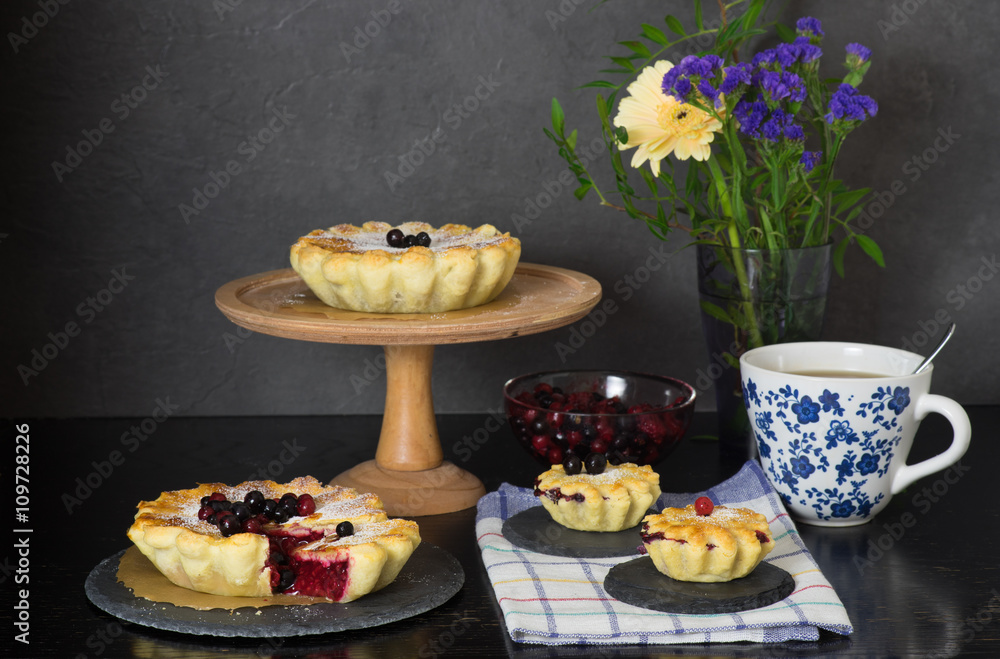 Still life with berry pies and cup of tea Still life with berry pies and cup of tea