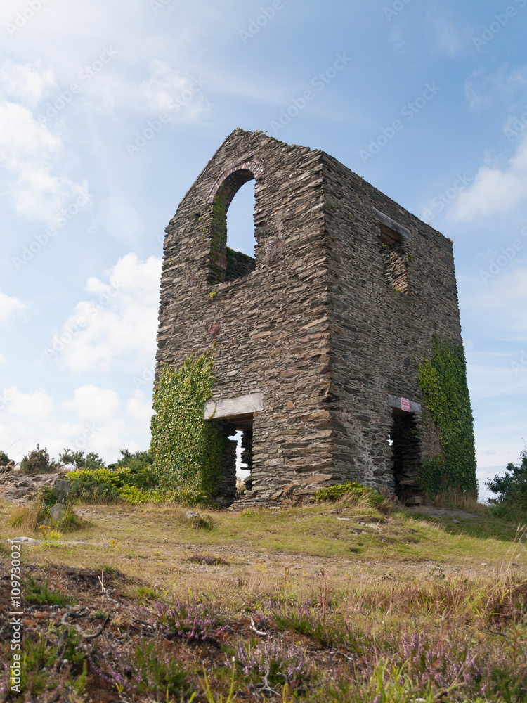 An old stone building ruin in the middle of the english countryside.