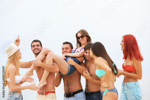 Beautiful young people having fun on beach © Africa Studio