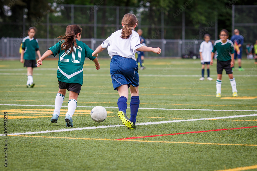 Girls playing soccer at the artificial turf field
