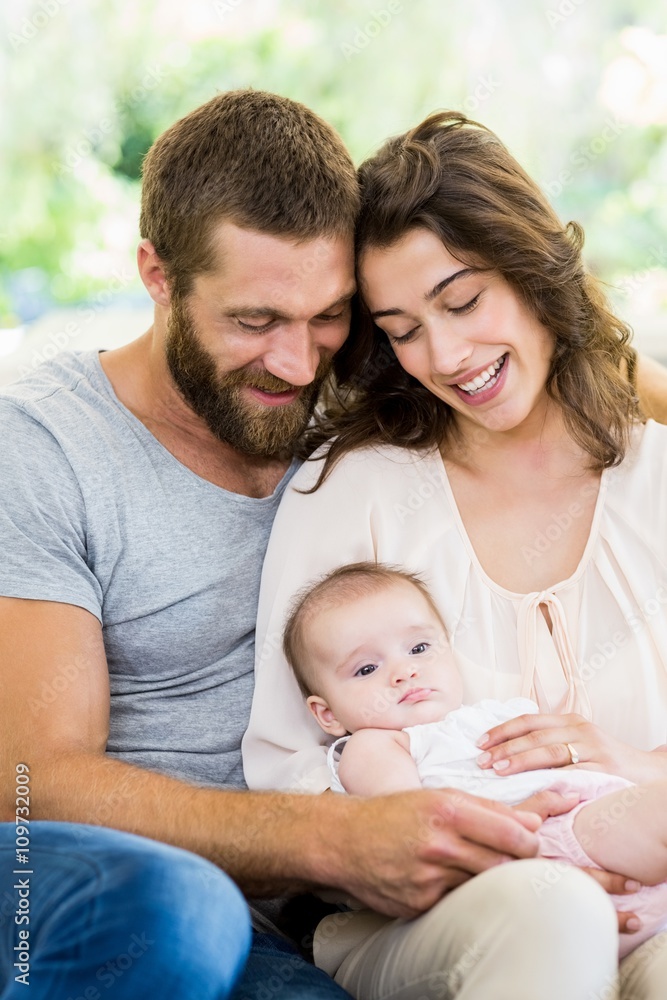 Happy parents with their baby in living room