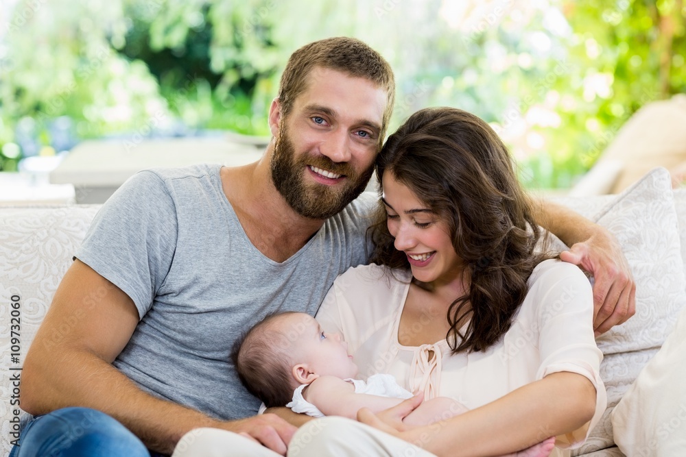 Happy parents with their baby in living room Happy parents with their baby in living room