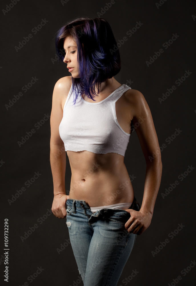 Sexy Woman in White Crop Top Removing Jeans Photos | Adobe Stock