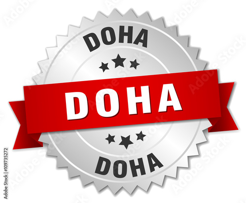 Doha round silver badge with red ribbon