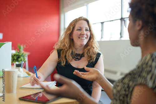 Unposed group of creative business people in an open concept office brainstorming their next project.