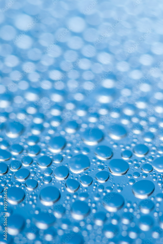 close-up of water drops on the blue background close-up of water drops on the blue background