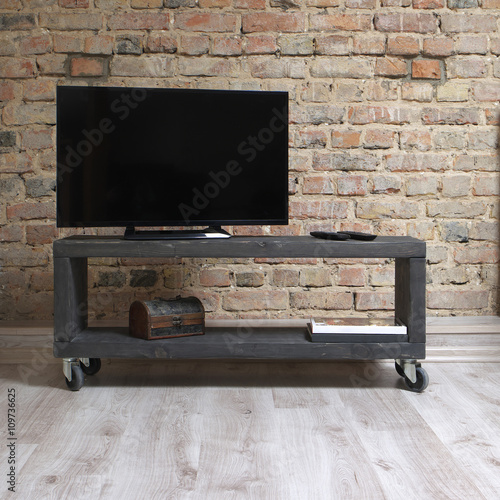 modern wooden tv unit in the loft interior 