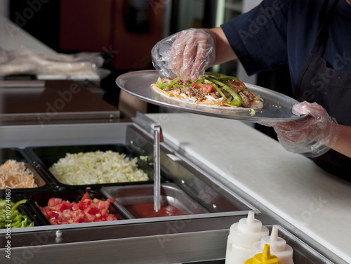 close-up of a chef making burrito.