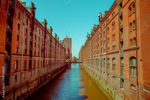 Large river canal with bricks buildings on the sides, sun and shadow, color mix © Fotos 593
