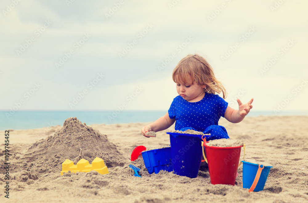 little girl play with sand on beach little girl play with sand on beach