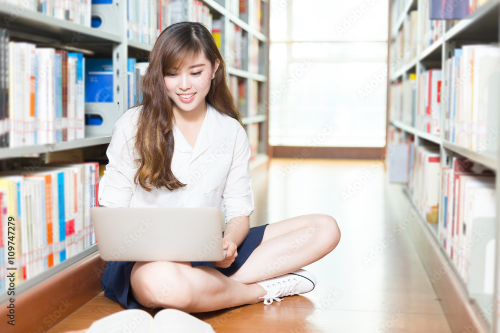 young beautiful asian girl university student with laptop in lib young beautiful asian girl university student with laptop in lib