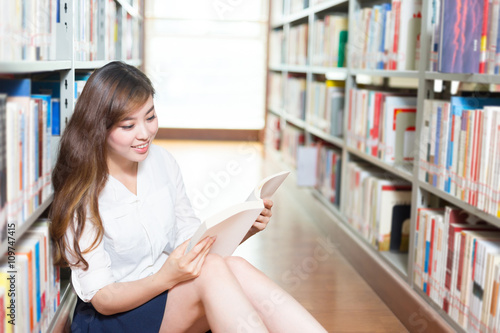 young beautiful asian girl university student in library