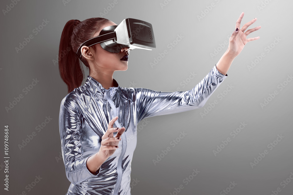 Beautiful young woman in silver latex costume and VR headset Stock Photo |  Adobe Stock