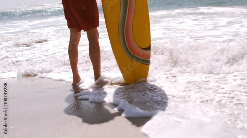 A man is standing in front of the sea photo