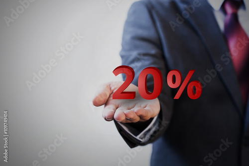 Businessman presenting 20 percent graphic on hand