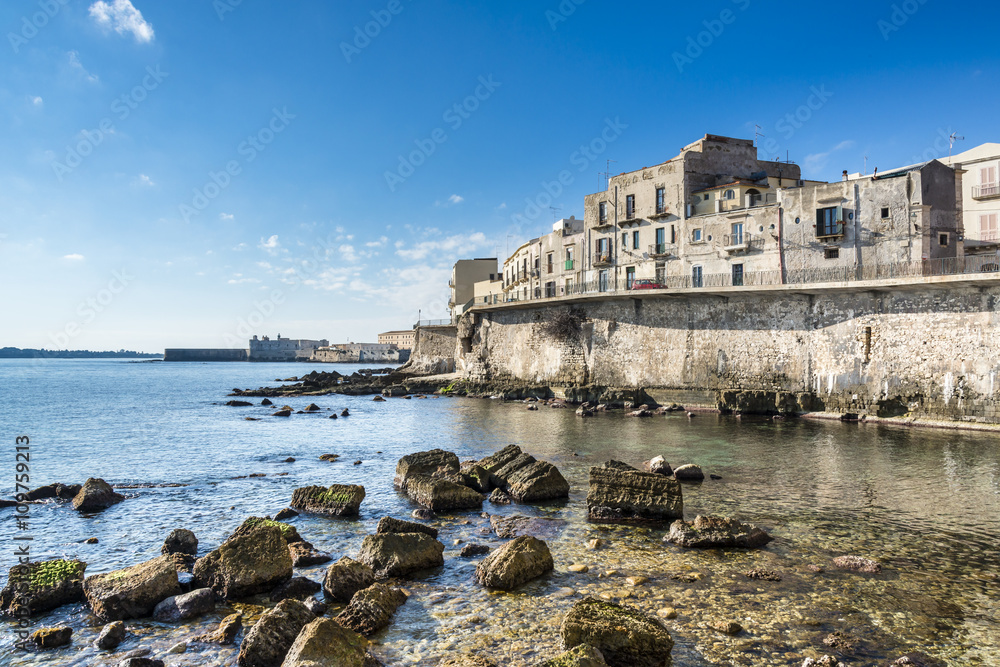 View of the Ortigia island and old stones on the Mediterranean coast , Syracuse, Sicily. Italy. 