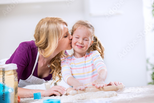 Lovely mother kissing worth daughter