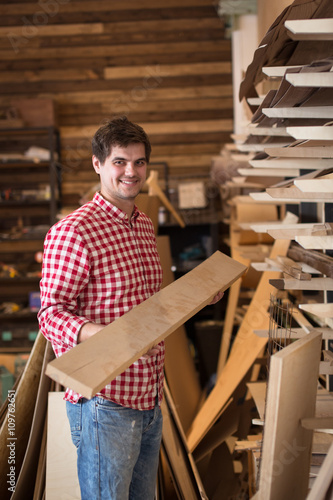 carpenter chooses a wooden board  joiner s shop  the concept of