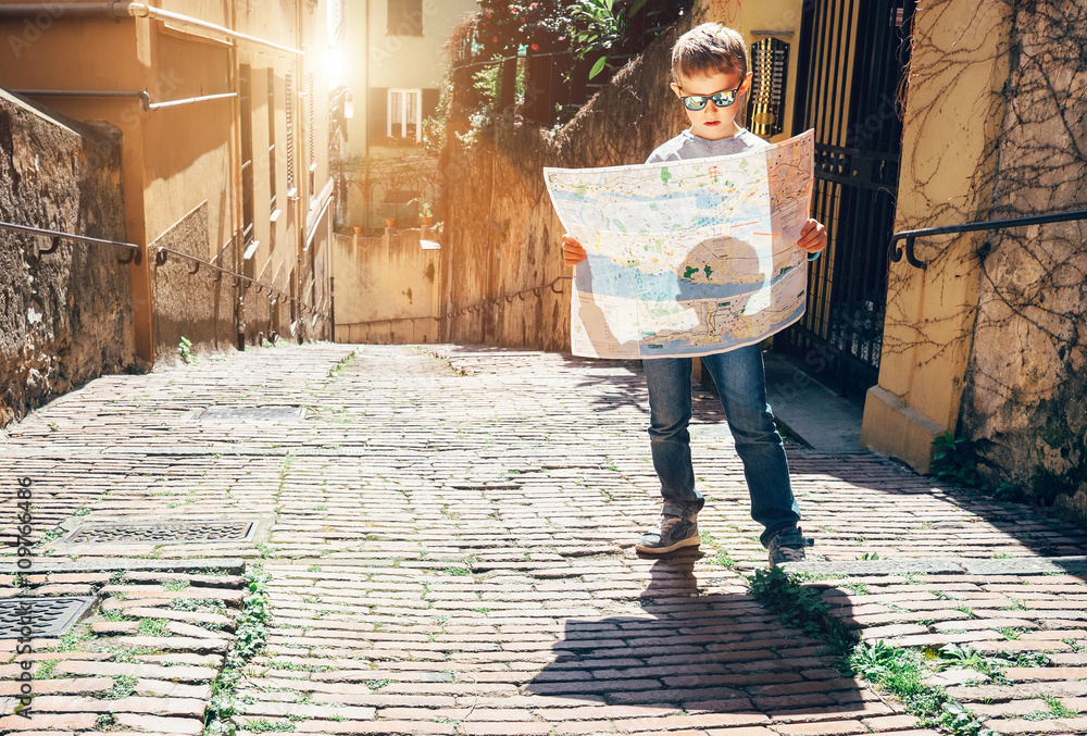 Fototapeta premium Young tourist with city map stay on the old italian street