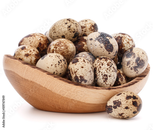 quail eggs in wooden bowl isolated on white background cutout