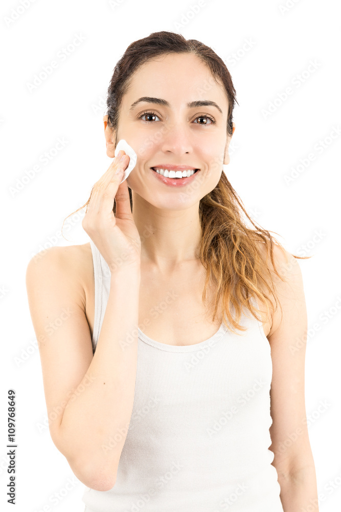 Woman cleaning her make up with a cotton ball Woman cleaning her make up with a cotton ball